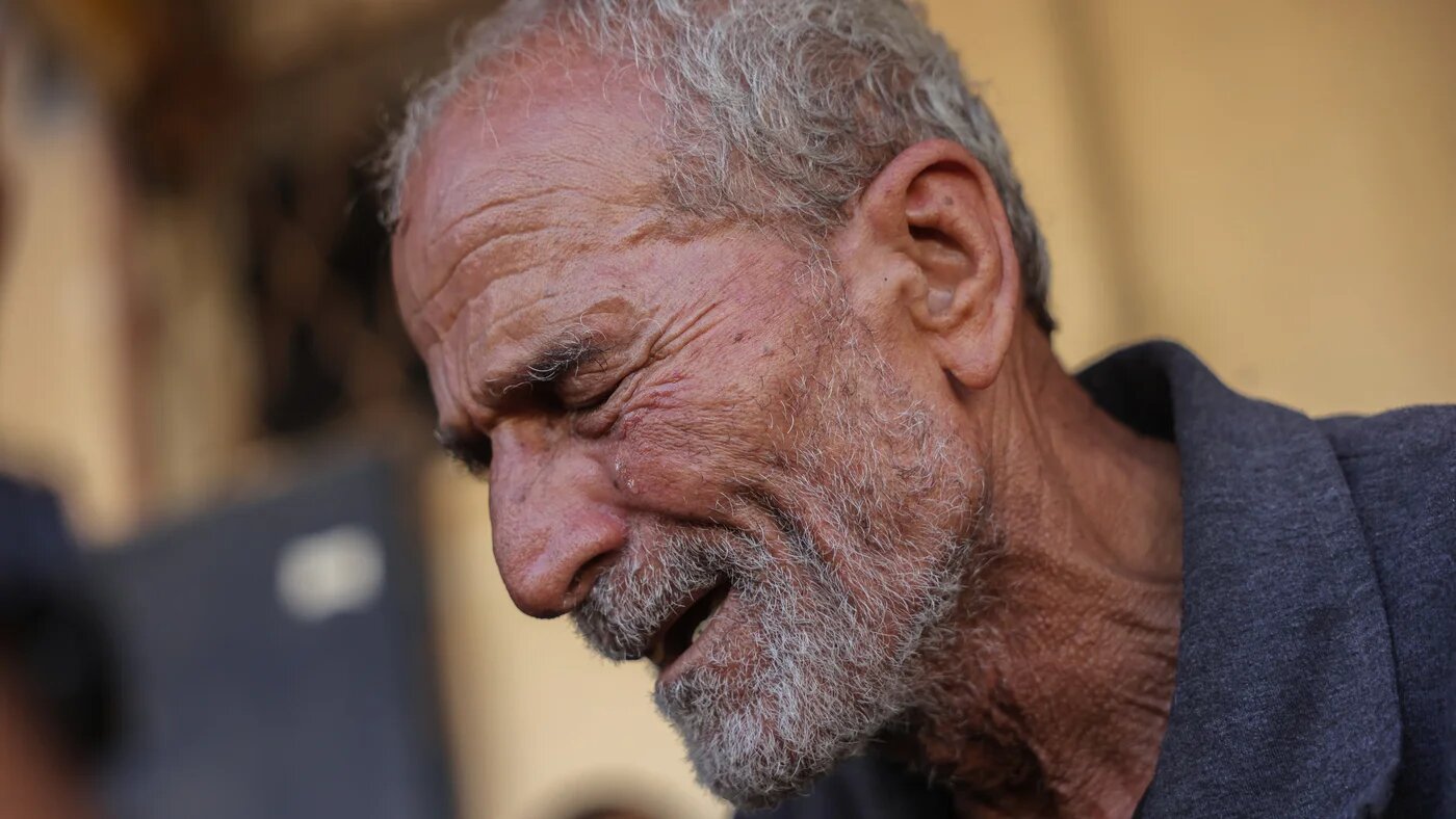 A Palestinian man mourns people killed by Israeli shelling, in Deir el-Balah, central Gaza Strip, on 1 October, 2025 (AFP/Bashar Taleb)