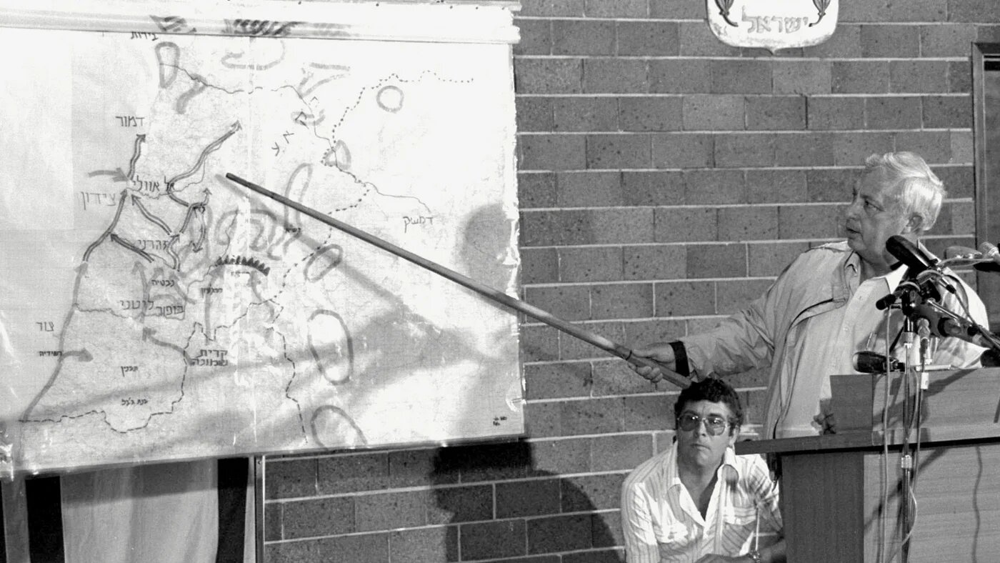 Israeli Defense Minister Ariel Sharon points to a map of Lebanon during a press briefing on the objectives of the military operation "Peace For Galilee" against Lebanon at the Defense Ministry in Tel Aviv, 11 June 1982 (AFP/GPO)