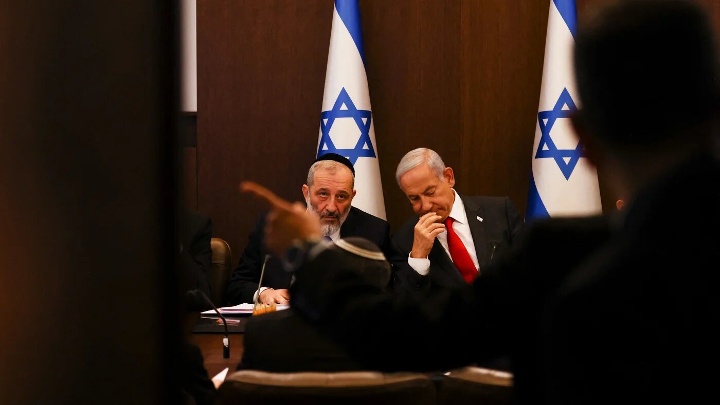 Israel's Prime Minister Benjamin Netanyahu sits next to Interior and Health Minister Aryeh Deri during a weekly cabinet meeting in Jerusalem on 8 January 2023 (AFP)