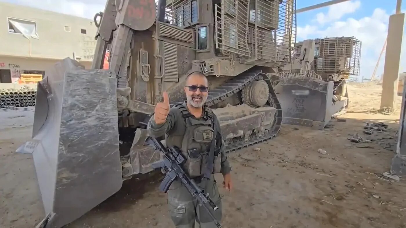 Avraham Zarbiv poses in front of a bulldozer in the Gaza Strip (Screengrab/Social media)