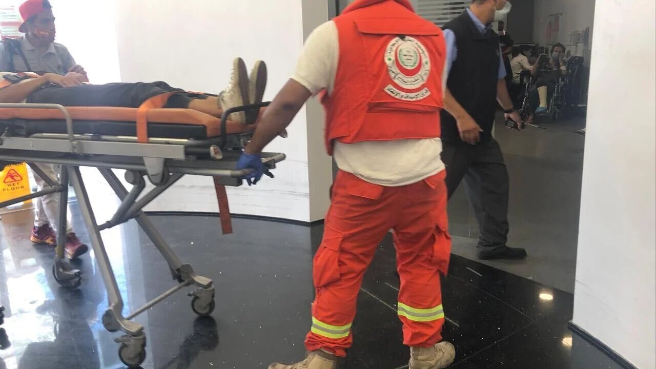 A patient carried on a stretcher at Hotel Dieu de France in Lebanon's Ashrafieh district