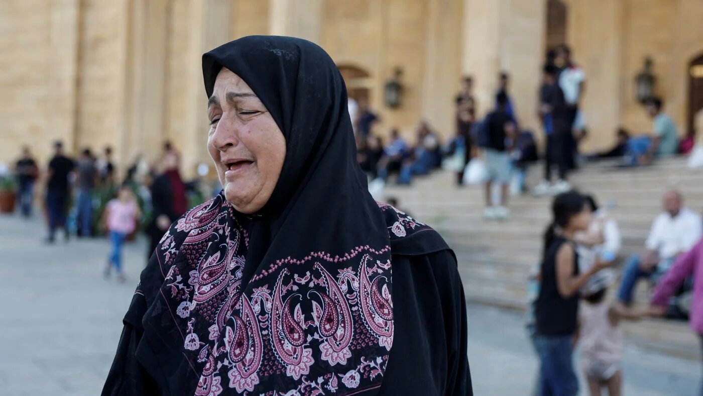 A woman reacts to the news of Hezbollah leader Hassan Nasrallah's killing in Beirut on 28 September 2024 (Louise Gouliamaki/Reuters)
