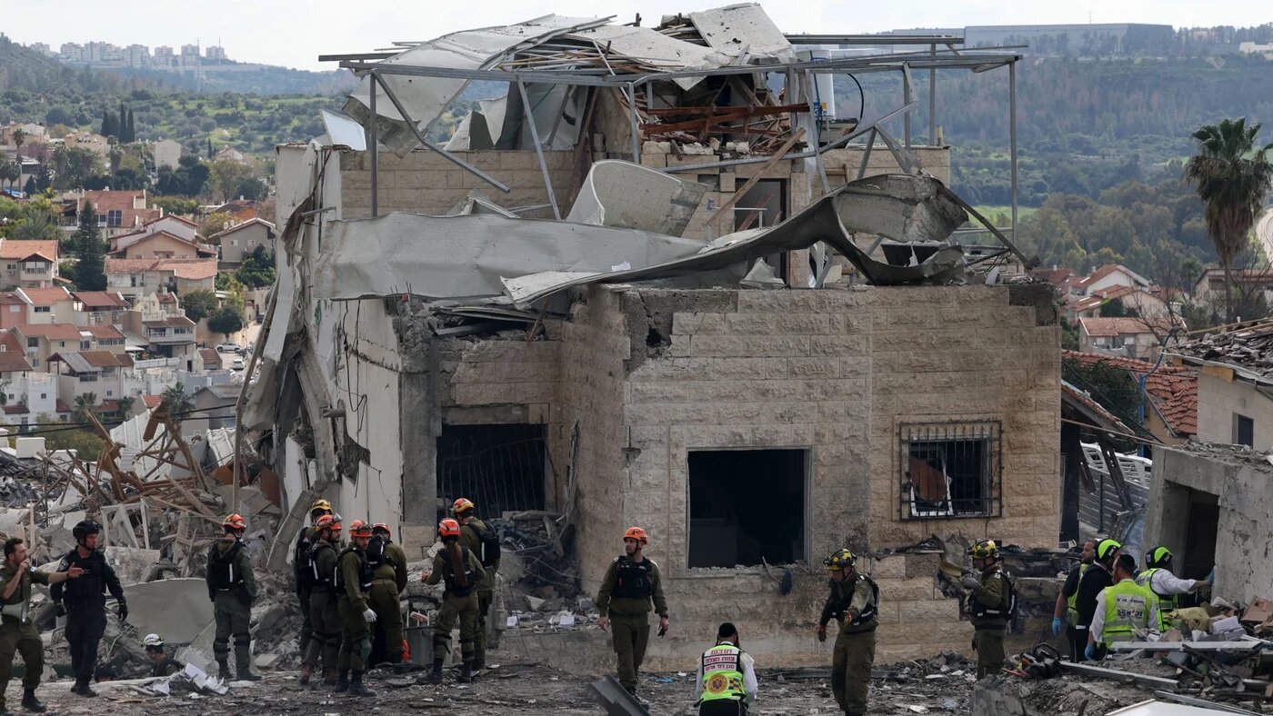 Israeli emergency service officers inspect destroyed house at the scene of a missile attack near Bet Shemesh, some 30 kilometres west of Jerusalem on 1 March 2026 (AFP/Ahmad Gharabli)