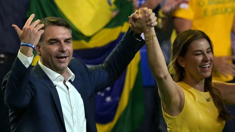 Presidential hopeful Flavio Bolsonaro appears with his wife, Fernanda, during the launch of his candidacy in Sao Paulo, Brazil, on 25 July 2026 (Nelson Almeida/AFP)