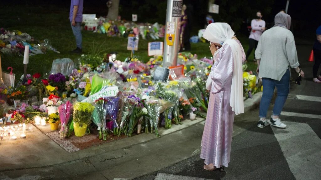 Members of the Muslim community and supporters light candles and place flowers at a memorial on 8 June in London, Canada.