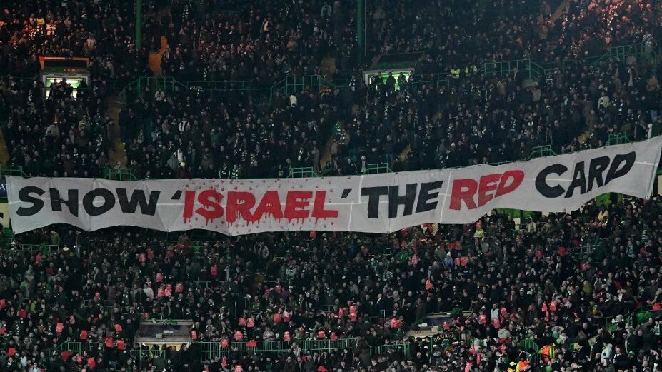 Celtic fans unveil a banner at a football match between Celtic and Bayern Munich in Glasgow, Scotland, on 12 February 2025 (Andy Buchanan/AFP)