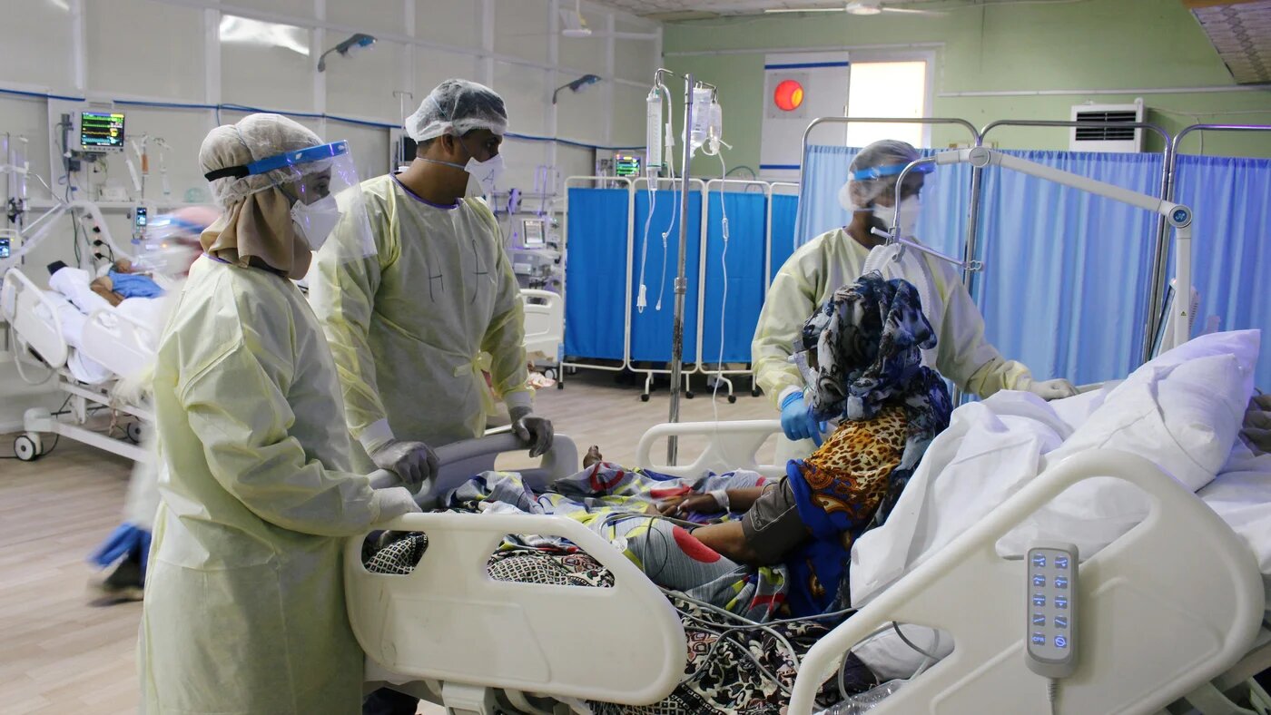 Doctors attend to a patient infected with the coronavirus disease in Aden, Yemen in June.