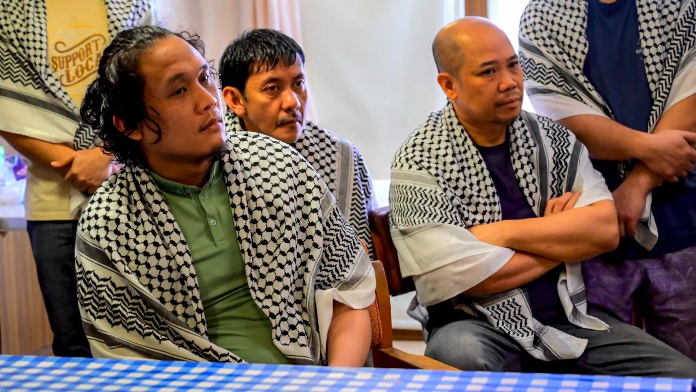 Captive crew members of the Israel-linked cargo vessel Galaxy Leader seized by Houthi fighters are gathered in the port city of Hodeidah, on 4 October 2024 (AFP)