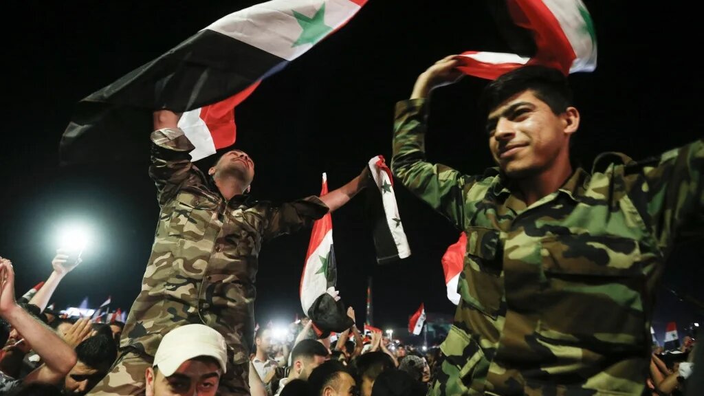 Des soldats syriens célèbrent la victoire du président Bachar al-Assad, qui remporte un quatrième mandat, à Damas, le 27 mai 2021 (AFP)