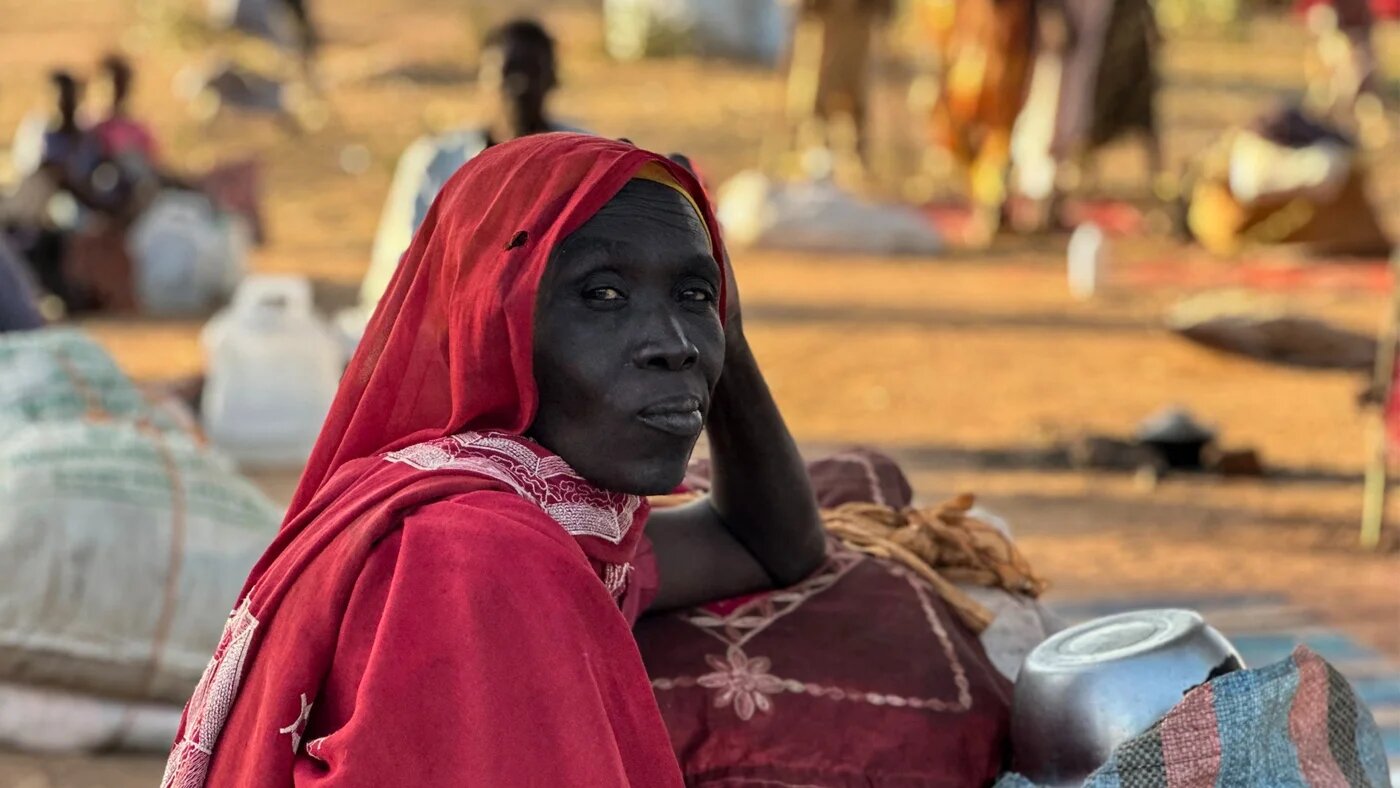 A displaced Sudanese woman who fled el-Fasher after the city fell to the Rapid Support Forces rests in the town of Tawila in Sudan’s war-torn western Darfur region on 28 October 2025 (AFP)