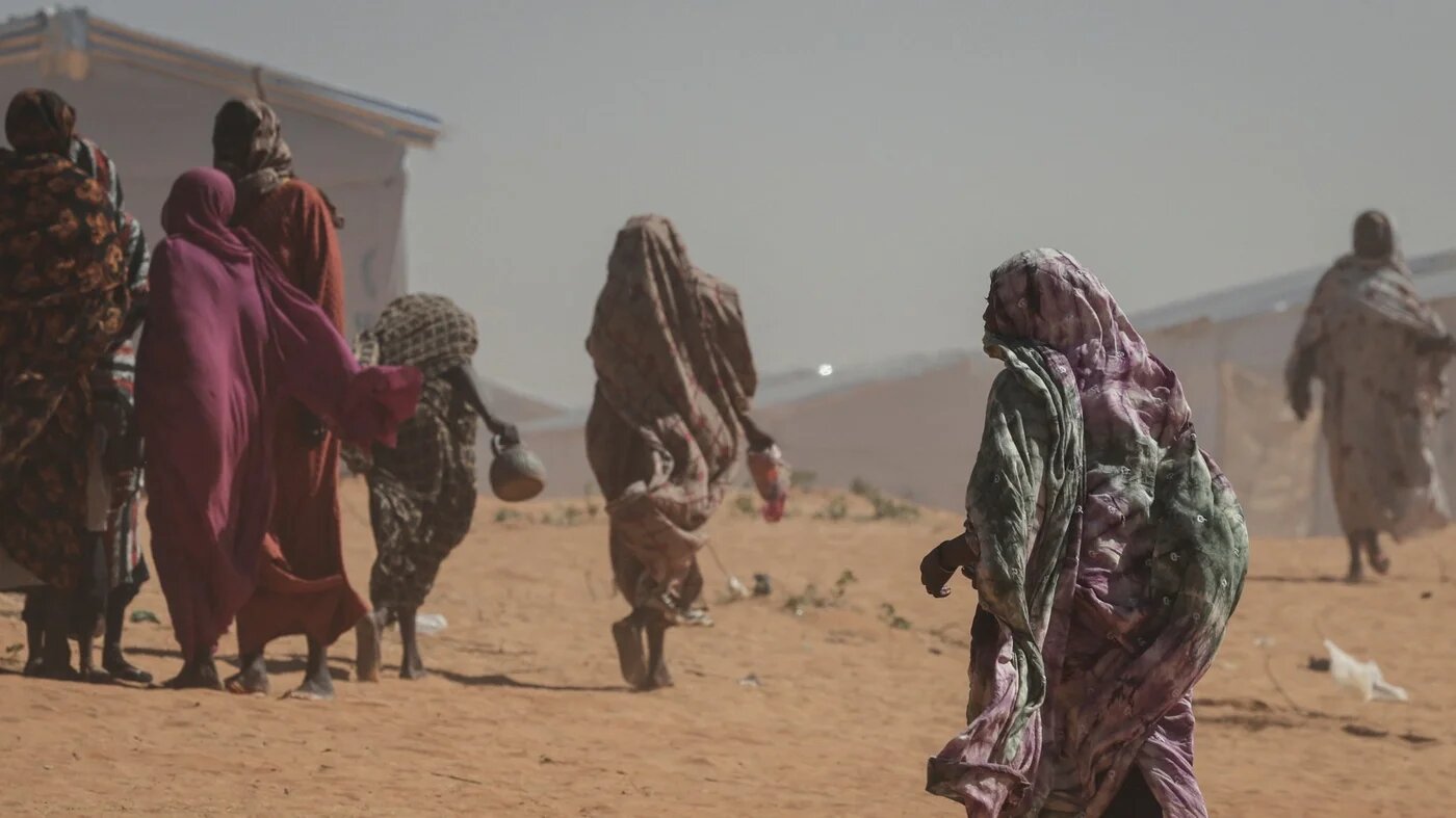 Sudanese women walk at the Tulum refugee camp, amid ongoing conflict in Sudan between the paramilitary Rapid Support Forces (RSF) and the Sudanese army, in Wadi Fira province, eastern Chad, 30 November 2025 (Amr Abdallah Dalsh/Reuters)