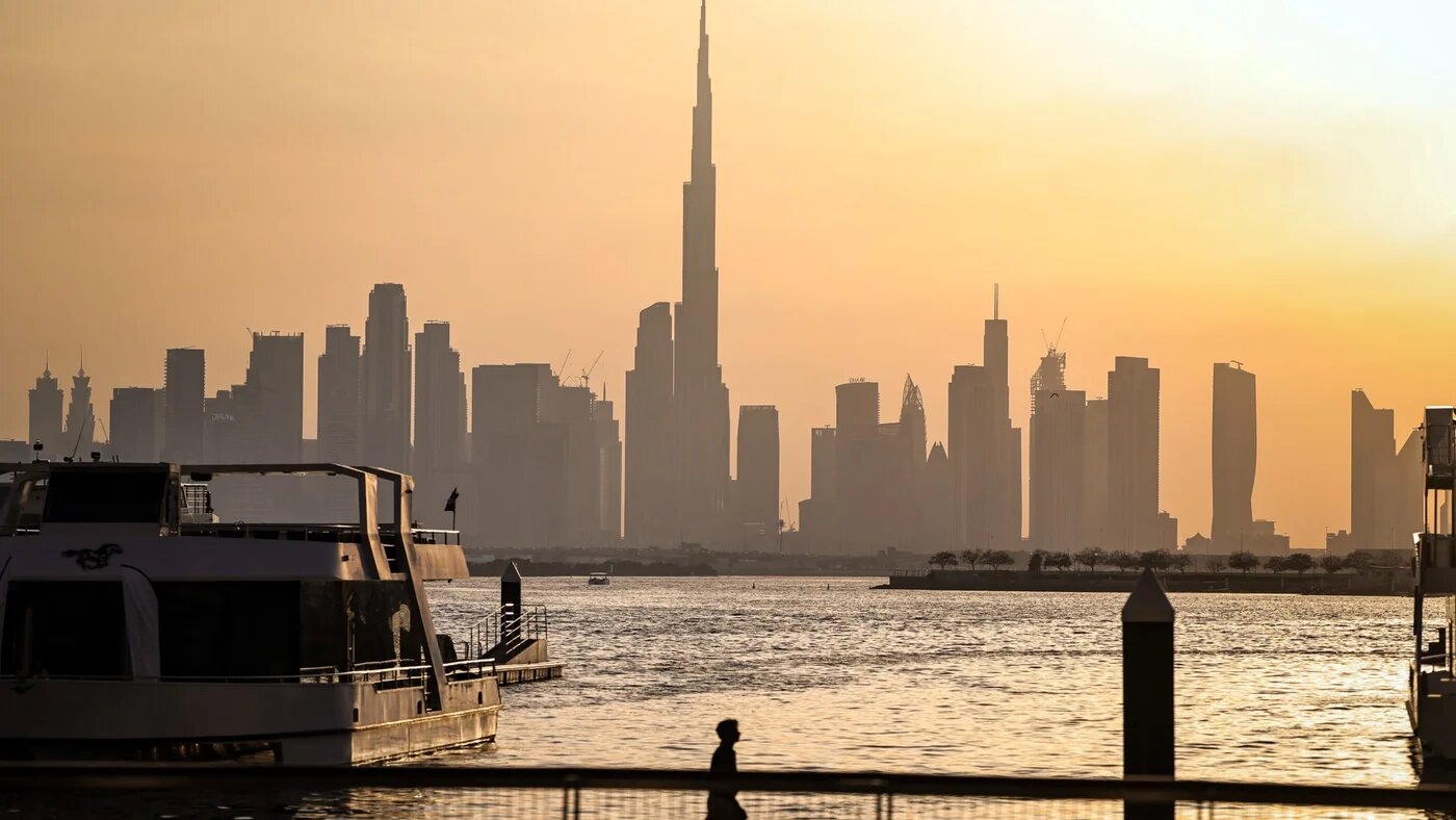 A man walks along Dubai's Creek Harbour, with the Burj Khalifa visible in the background, on 3 April 2026 (Fadel Senna/AFP)
