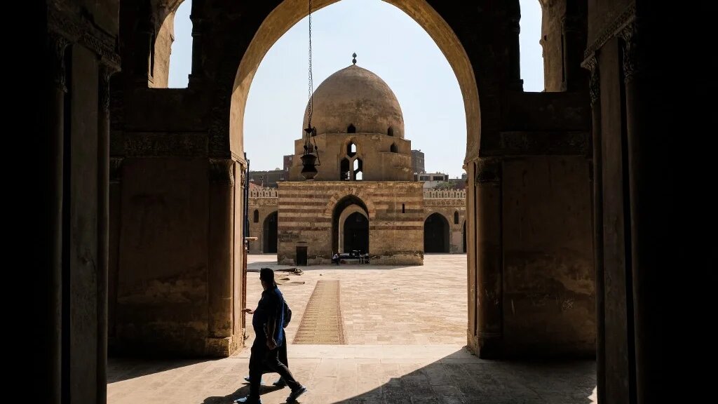 Visitors walk at the ninth-century mosque of Ibn Tulun in the historic quarter of the Egyptian capital Cairo on 4 May 2022. (AFP)