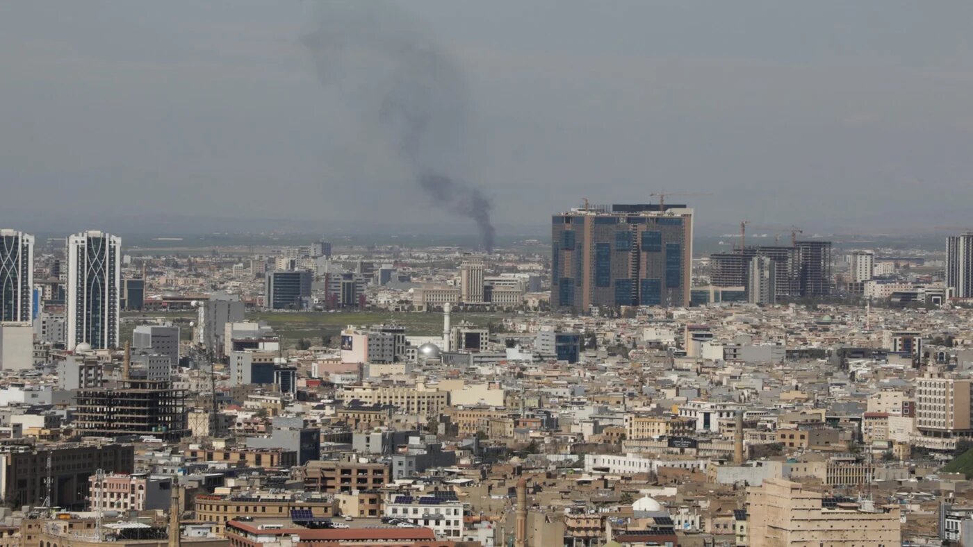 A plume of smoke rises following an interception of a drone in Erbil on 12 March 2026 (AFP/Shvan Harki)