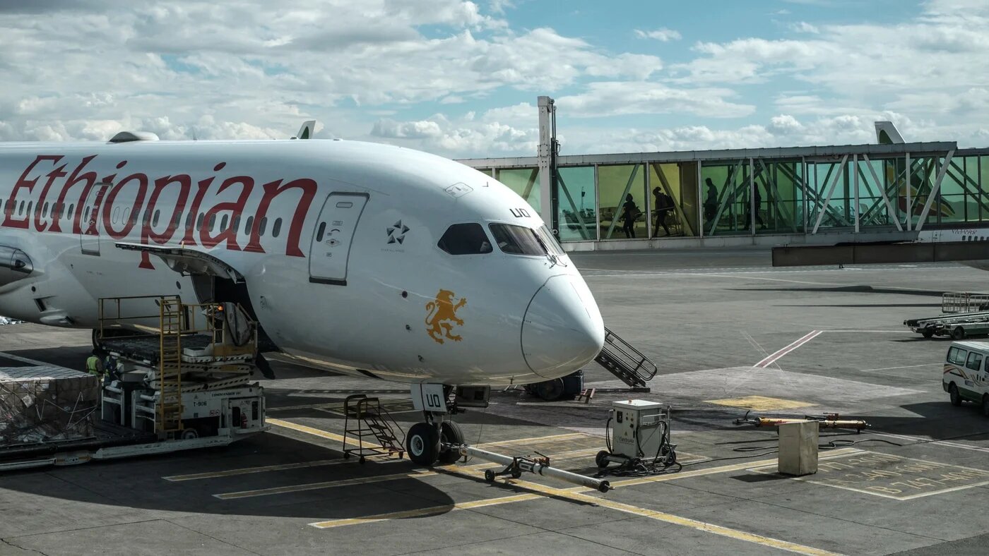 People board an Ethiopian Airlines plane at the Bole International Airport, in Addis Ababa, on 17 March 2020 (Eduardo Soteras/AFP)