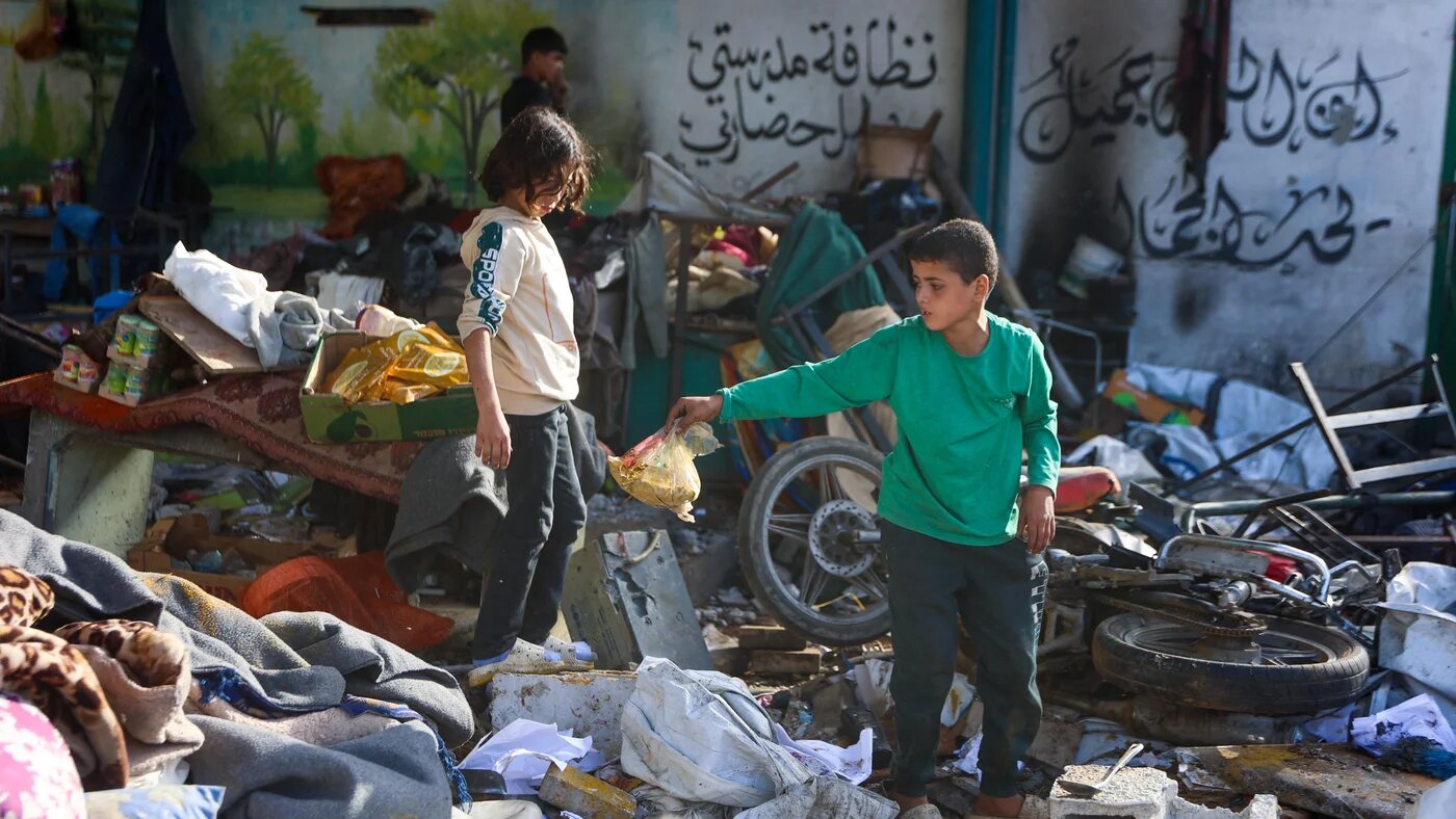 Palestinian children search through the rubble at the Fahmi Al-Jarjawi School in Gaza City on 26 May 26, 2025, following an Israeli strike that killed dozens, including children (AFP/Omar Al-Qattaa)