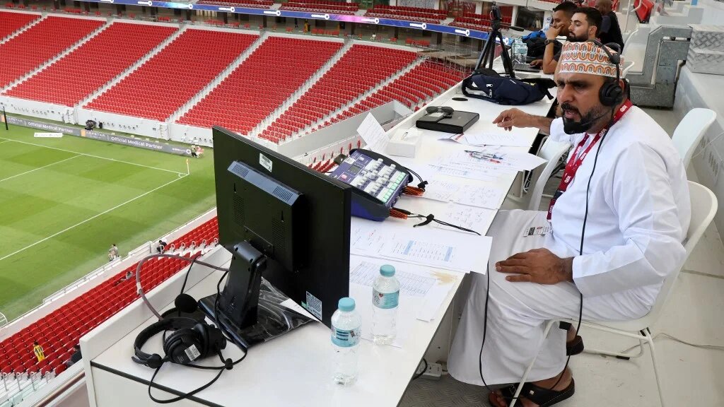 Omani commentator Khalil al-Balushi oversees the Qatar Stars League football match between Al-Gharafa and Al-Ahli  (AFP)
