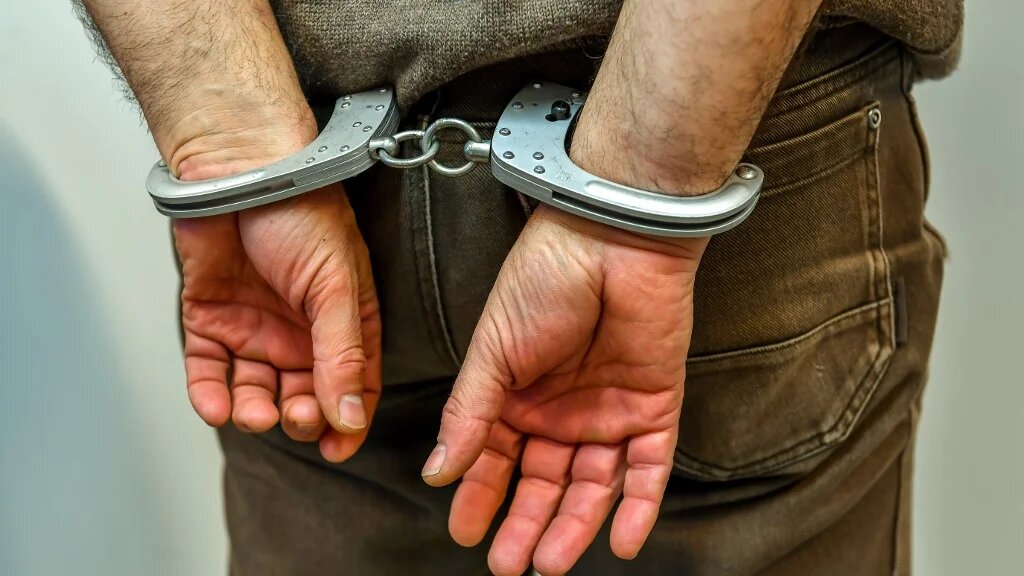 A man in handcuffs in France