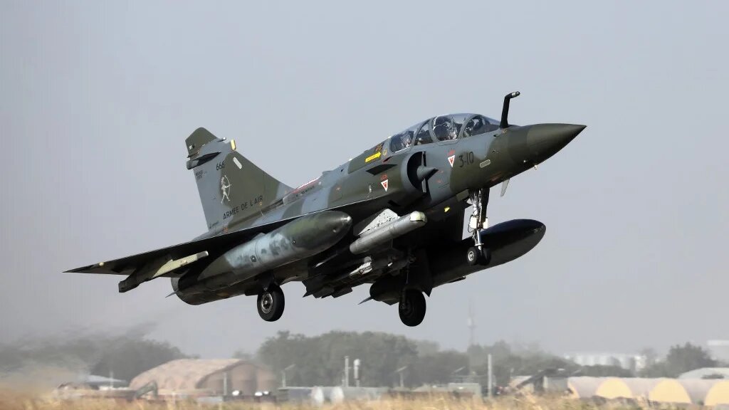 The French military said a fighter jet had struck a jihadist group at a location north of the village, killing several dozen combatants.
