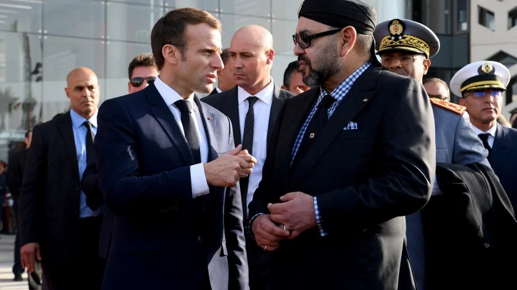 King Mohammed VI (R) speaks with Emmanuel Macron after inaugurating a high-speed line at Rabat train station in November 2018 (Christophe Archambault/AFP)