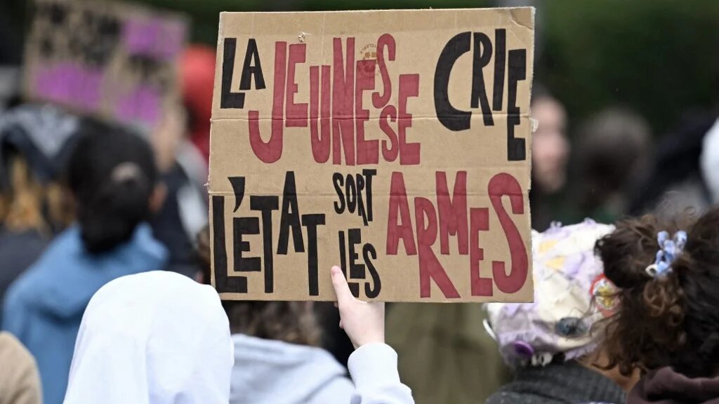 A placard reads "The youth shouts, the state brings out its weapons" during a student protest in eastern France, on 8 October 2026 (Jean-Christophe Verhaegen/AFP)