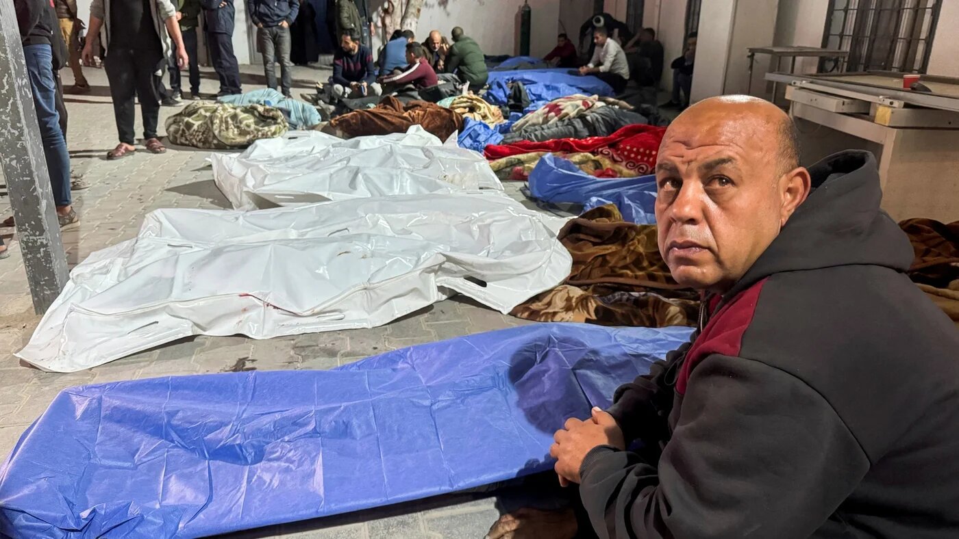 Mourners gather near the bodies of Palestinians killed in Israeli strikes, at a hospital in Gaza City 18 March (Reuters)
