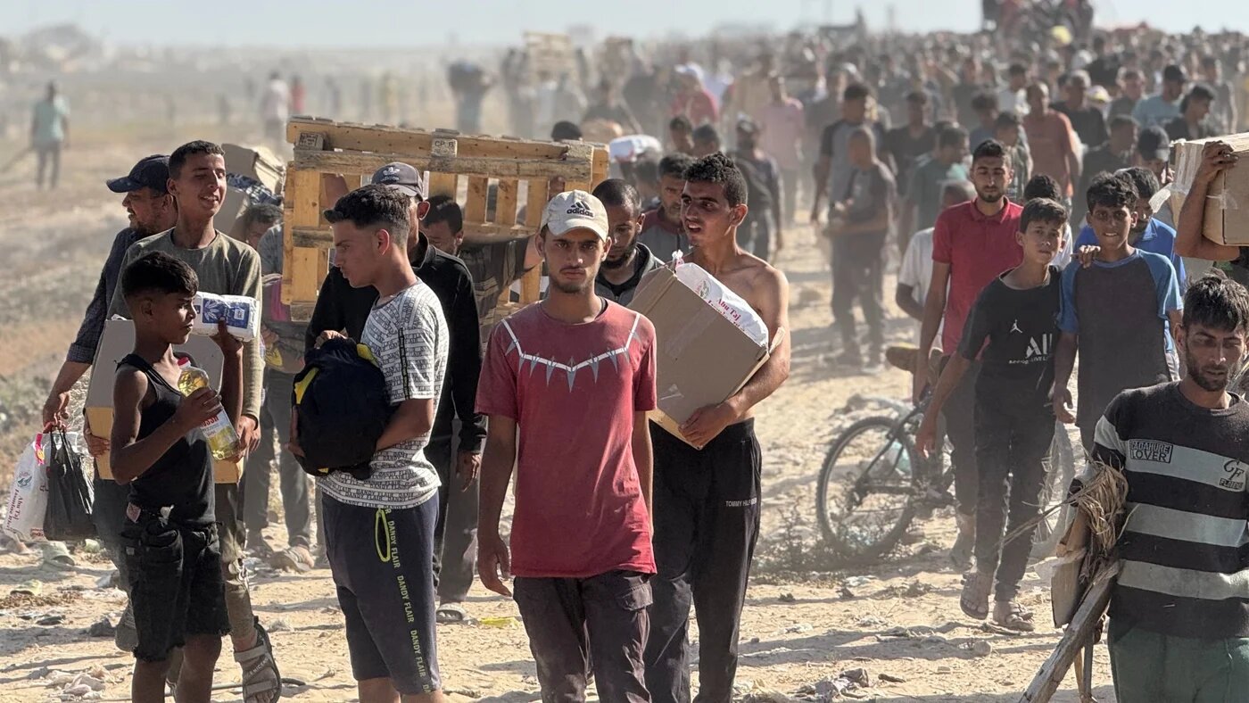 Displaced Palestinians receive food packages from a US-backed foundation in western Rafah in the southern Gaza Strip on 27 May 2025 (AFP)