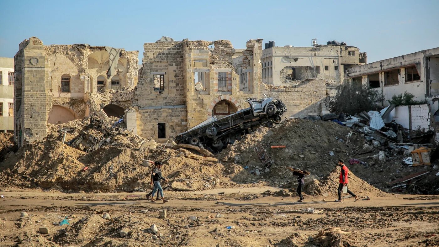 People walk in front of Gaza City's 17th-century Qasr al-Basha, or the Pasha's Palace, on 5 January 2024 (AFP/Omar al-Qattaa)