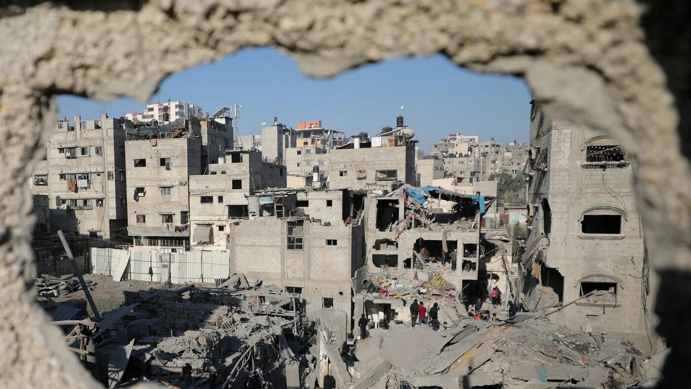 Palestinians inspect the aftermath of an Israeli air strike on a house in Gaza City on 19 December 2024 (Reuters/Dawoud Abu Alkas)