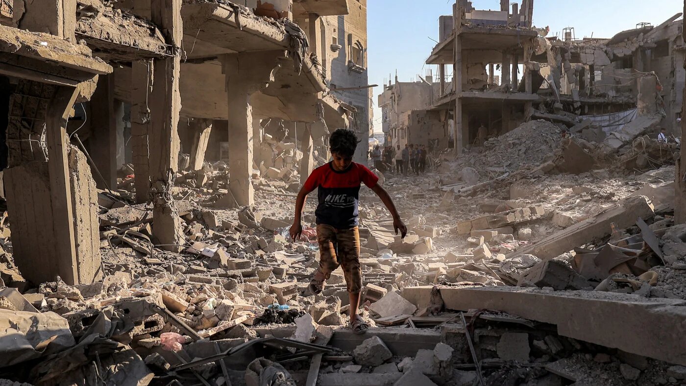 A boy walks through the rubble of a building that was destroyed following Israeli bombardment at the Maghazi refugee camp in the central Gaza Strip on 12 June 2026 (Eyad Baba/AFP)