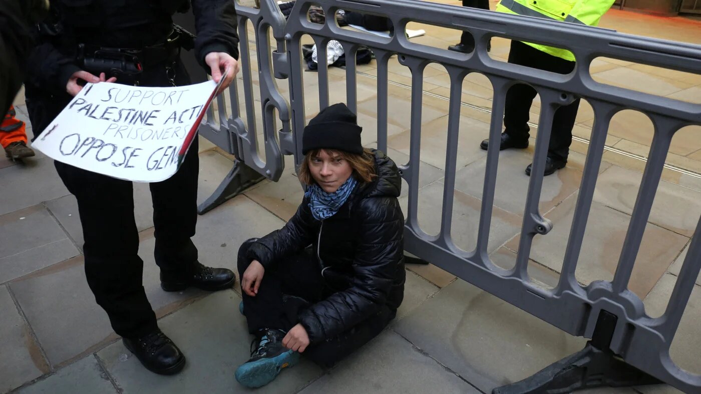 Swedish activist Greta Thunberg before her arrest by police officers outside the offices of Aspen Insurance at Plantation Place on Fenchurch Street on 23 December 2025 (Prisoners for Palestine/AFP)