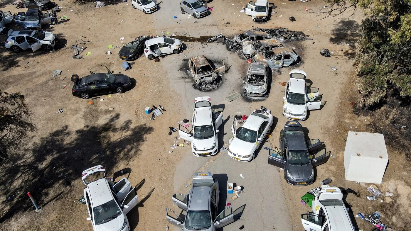 Abandoned and torched vehicles near Kibbutz Re'im in southern Israel on 13 October 2023 (AFP)