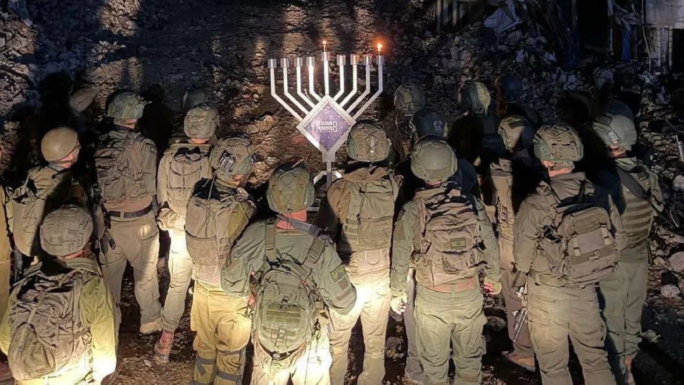 Israeli troops pictured lighting Hanukkah candles inside Tulkarm refugee camp in the occupied West Bank on 14 December 2025 (Social media)