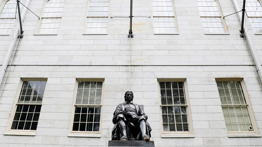 A statue of John Harvard is pictured on the university’s campus in Cambridge, Massachusetts, on 8 July 2020 (AFP)