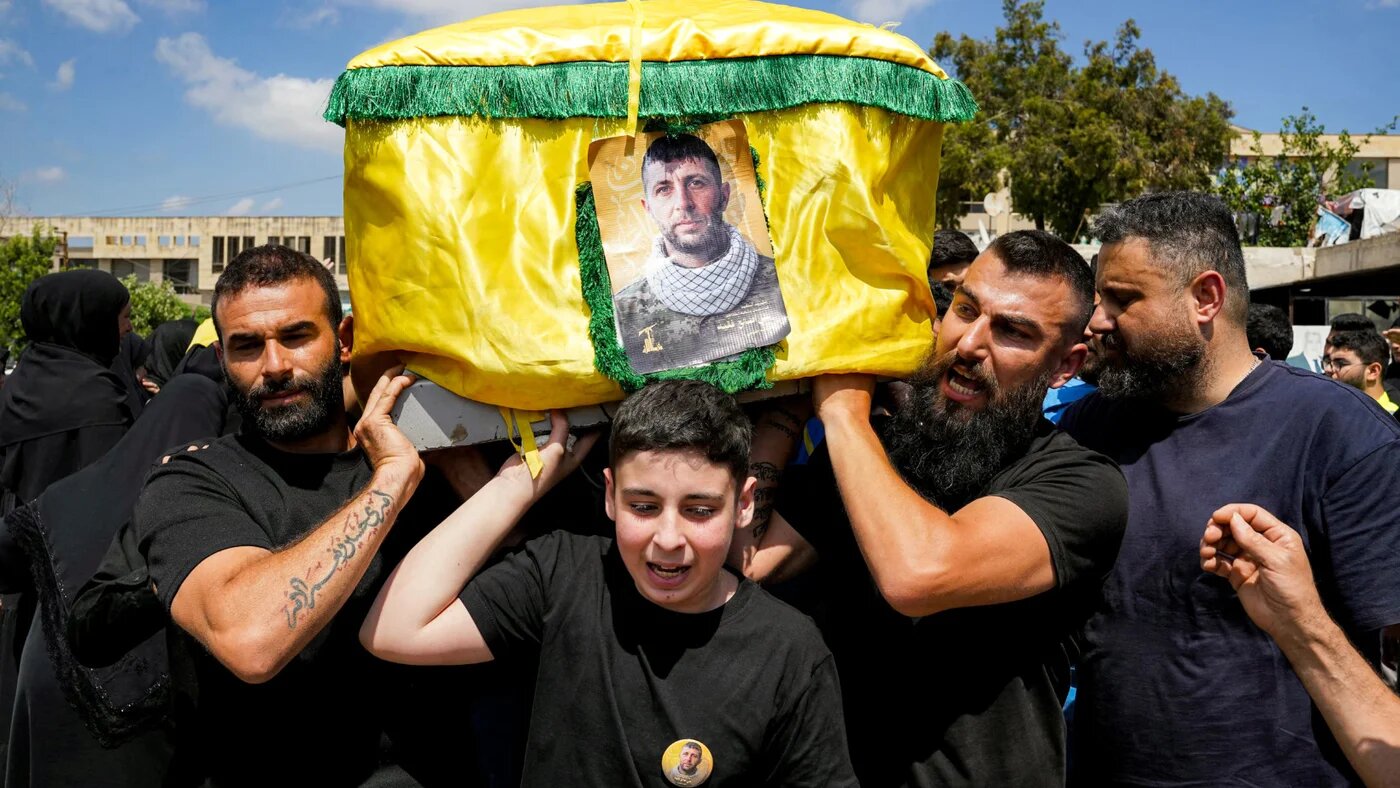 Mourners carry the casket of a slain Hezbollah fighter during his funeral in Nabatieh in southern Lebanon on 23 June 2026 (Abbas Fakih/AFP)