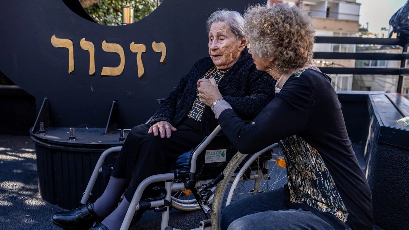 Miriam Linial (L), a 103 years old Holocaust and Auschwitz concentration camp survivor, attends the the International Holocaust Memorial Day, in Haifa, on 27 January 2025 (AFP/Menahem Kahana)
