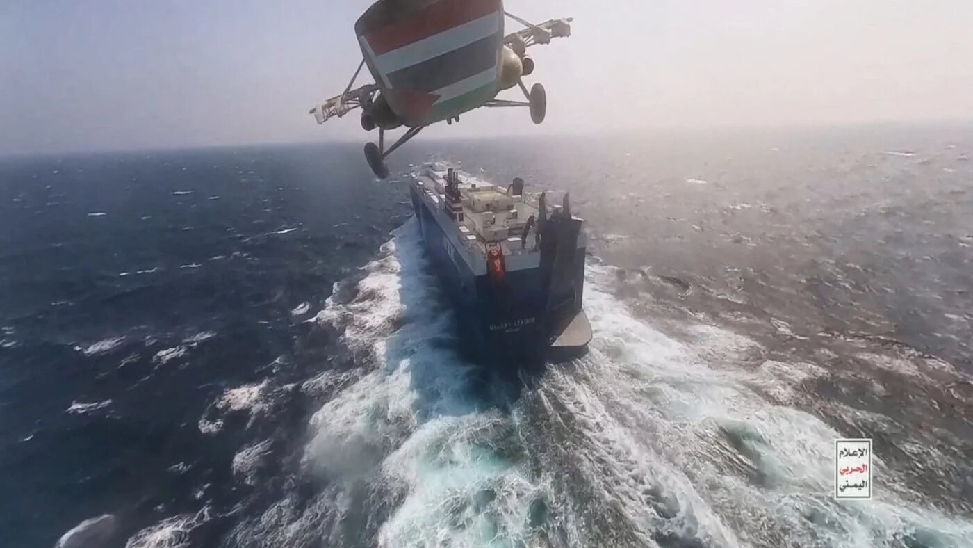 Houthi military helicopter flies over the Galaxy Leader cargo ship in the Red Sea, 20 November 2023 (Houthi military media handout/Reuters)