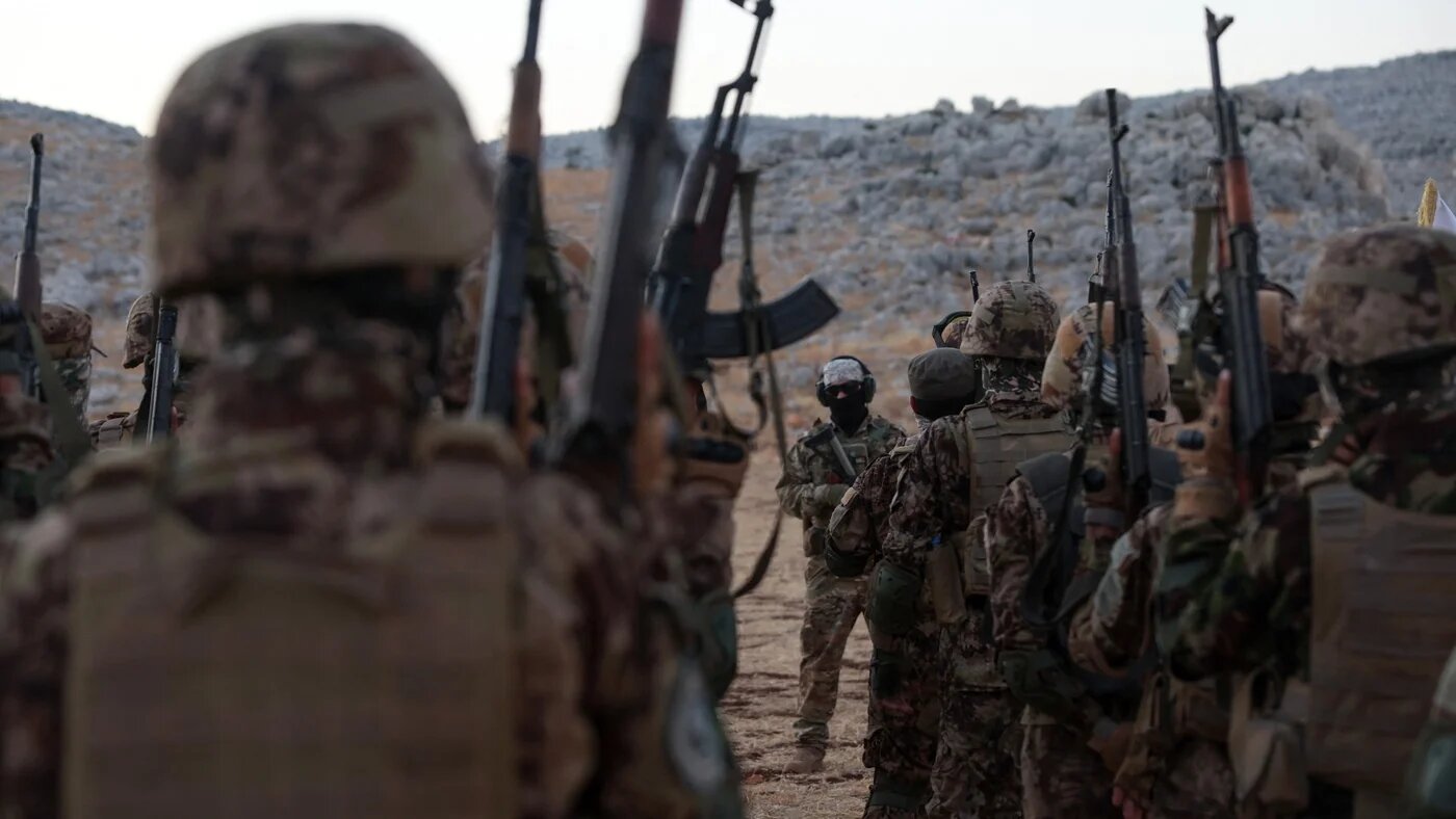 Fighters from the jihadist group Hay'at Tahrir al-Sham in Idlib province on 16 August, 2023 (AFP/Omar Haj Kadour)