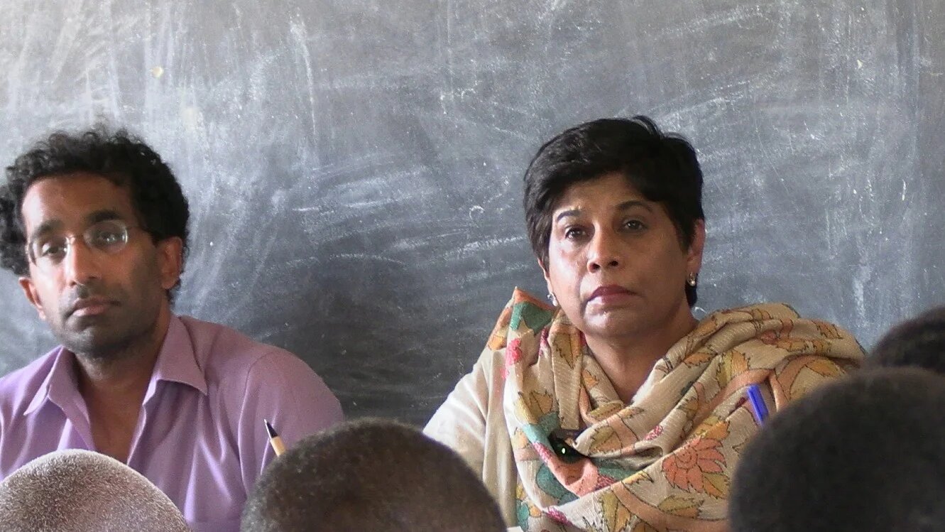 ICC Deputy Prosecutor (R) and head of the Darfur unified team Pubudu Sachithanandan speak to victims in a refugee camp in Chad, 7 July 2026 (ICC/X)
