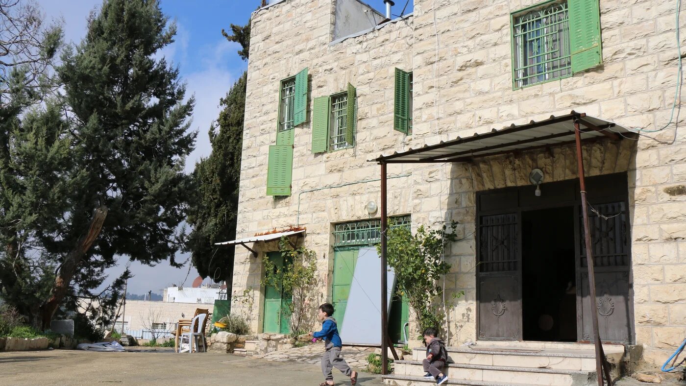 Abu Srour's two young boys play in front of the family home in the exact spot where settlers attacked their father days before (MEE/Akram al-Wa'ara)