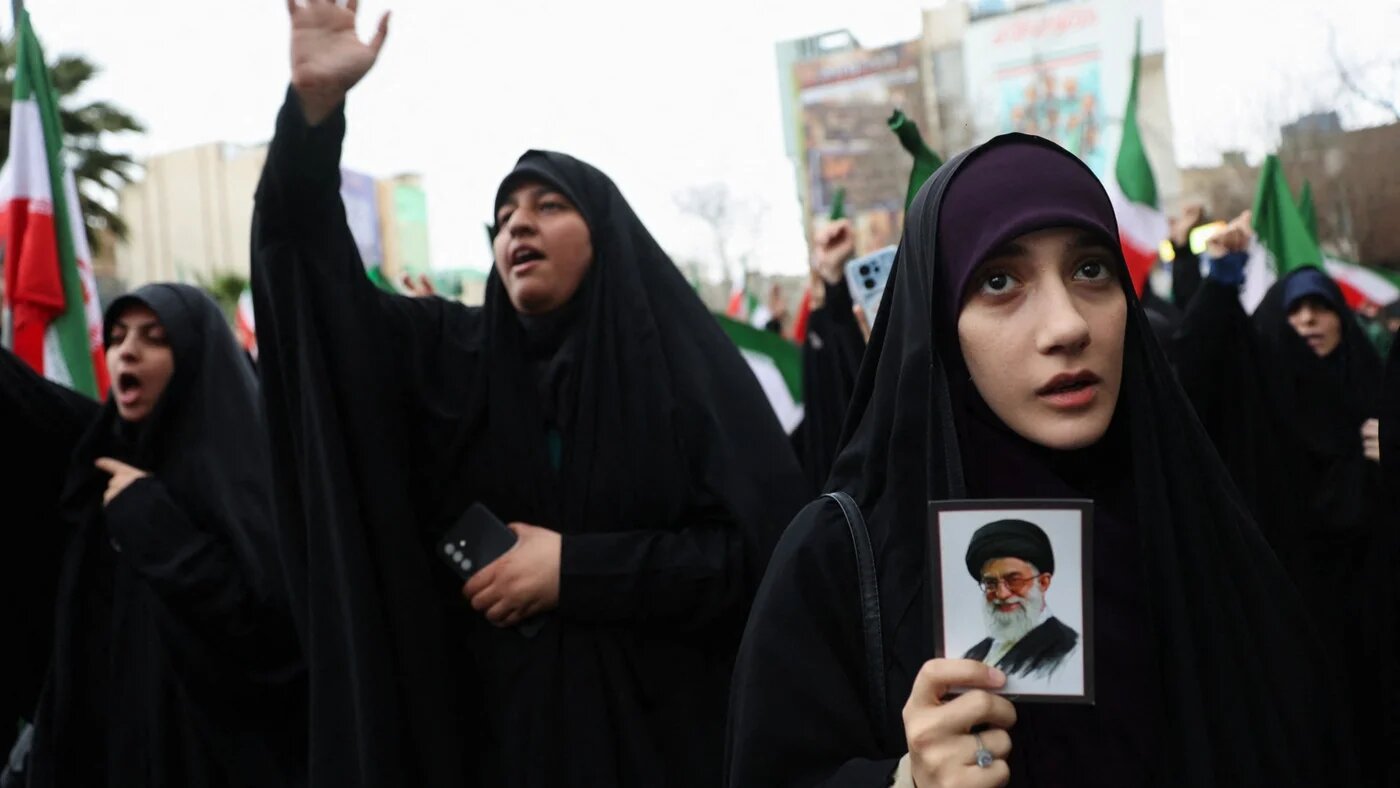 A woman holds an image of Iran's Supreme Leader Ayatollah Ali Khamenei as Iranians protest against the US-Israeli strikes, in Tehran, 28 February 2026 (Majid Asgaripour/WANA via Reuters)
