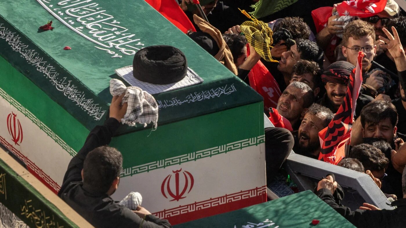 Mourners react next to the coffin of Iran's late Supreme Leader Ayatollah Ali Khamenei, who was killed on 28 February in Israeli and US air strikes, and coffins of his family members, on the day of his burial, in a culmination of a mass funeral, in Mashhad, Iran, 9 July 2026 (Alkis Konstantinidis/Reuters) 