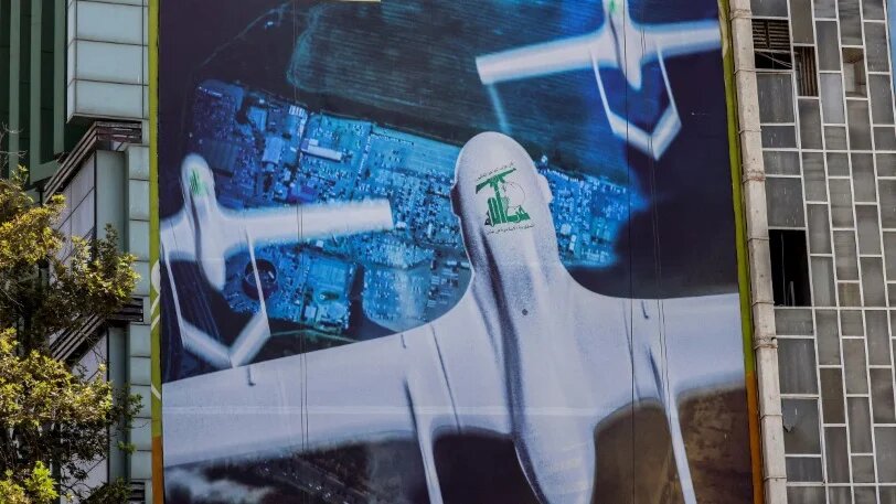 A giant banner depicting a drone bearing the emblem of Hezbollah is pictured on a building in the Iranian capital Tehran, on 31 August 2024 (Atta Kenare/AFP)