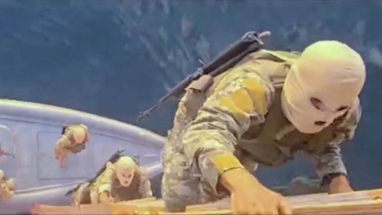 A screen capture from a video said to show the seizure of the container ships MSC Francesca and Epaminondas in the Strait of Hormuz, broadcast on Iranian State TV, and released 22 April 2026, shows soldiers taking part in the operation (IRIB/Handout via Reuters)