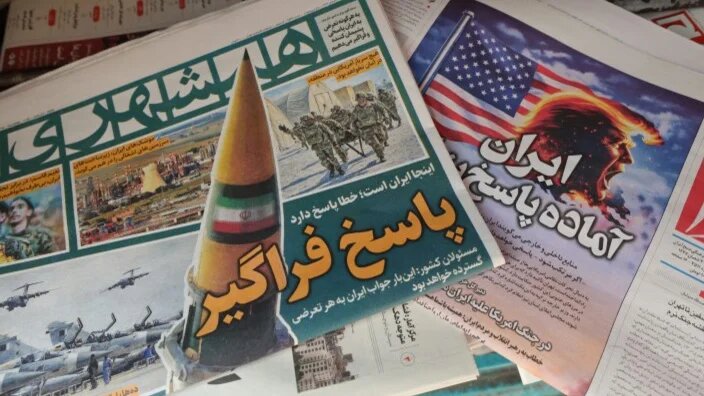 Newspapers at a kiosk in Tehran are pictured on 27 January 2026, one with a headline reading: “Iran is ready for a big response”, amid speculation about a US attack (Atta Kenare/AFP)