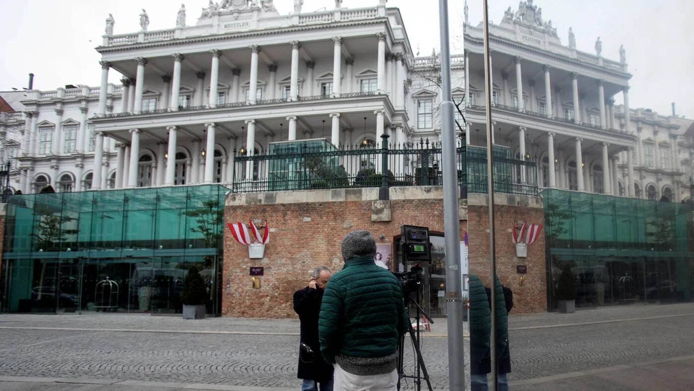 Journalists wait outside the Hotel Palais Coburg, where resumption of talks aimed at reviving the 2015 Iran nuclear deal are taking place in Vienna on 27 December 2021.