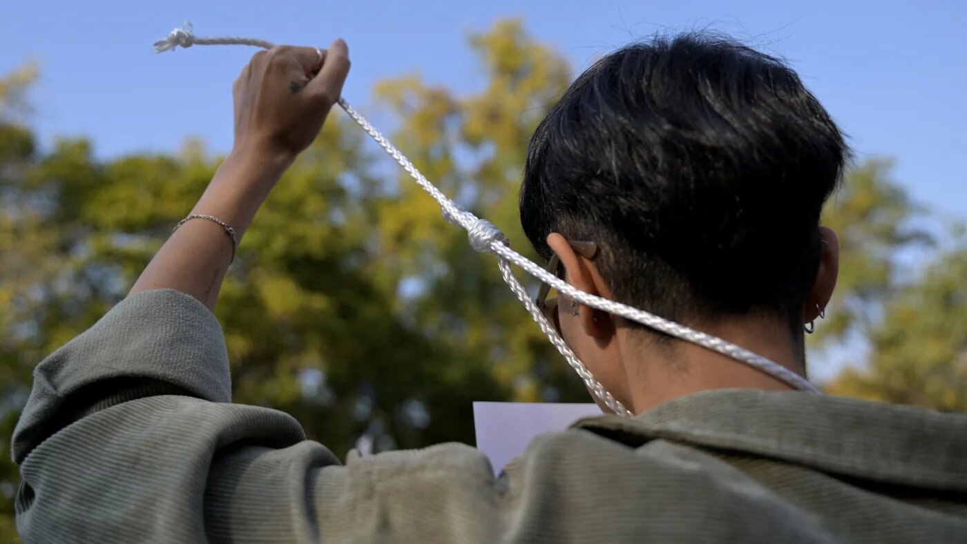 People take part in a protest against the execution of Iranian footballer Amir Nasr-Azadani and to demand human righst in Iran, in front of the Iranian embassy in Mexico City on 19 December 2022 (AFP)