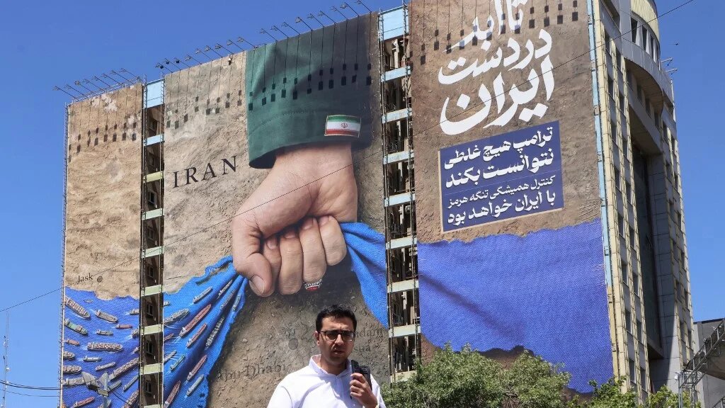 A billboard depicts the Strait of Hormuz with a caption in Persian reading “Forever in Iran’s Hand”, at Tehran’s Vanak Square on 25 May 2026 (Atta Kenare/AFP)