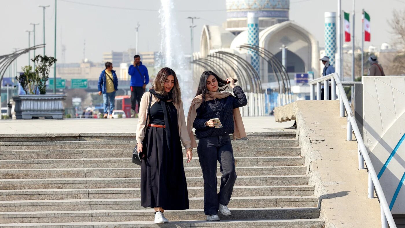 Iranians walk through Azadi Square in Tehran on 23 February 2026 (AFP)