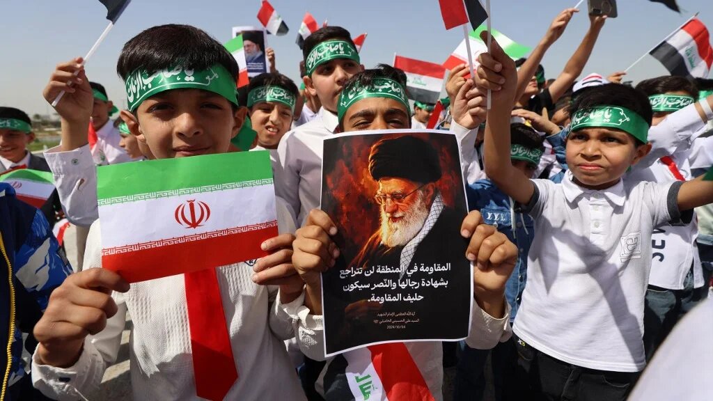An Iraqi demonstrator in Baghdad holds a portrait of Iran's slain supreme leader, Ayatollah Ali Khamenei, during a protest against the US-Israeli war on 7 April 2026 (Ahmad al-Rubaye/AFP)